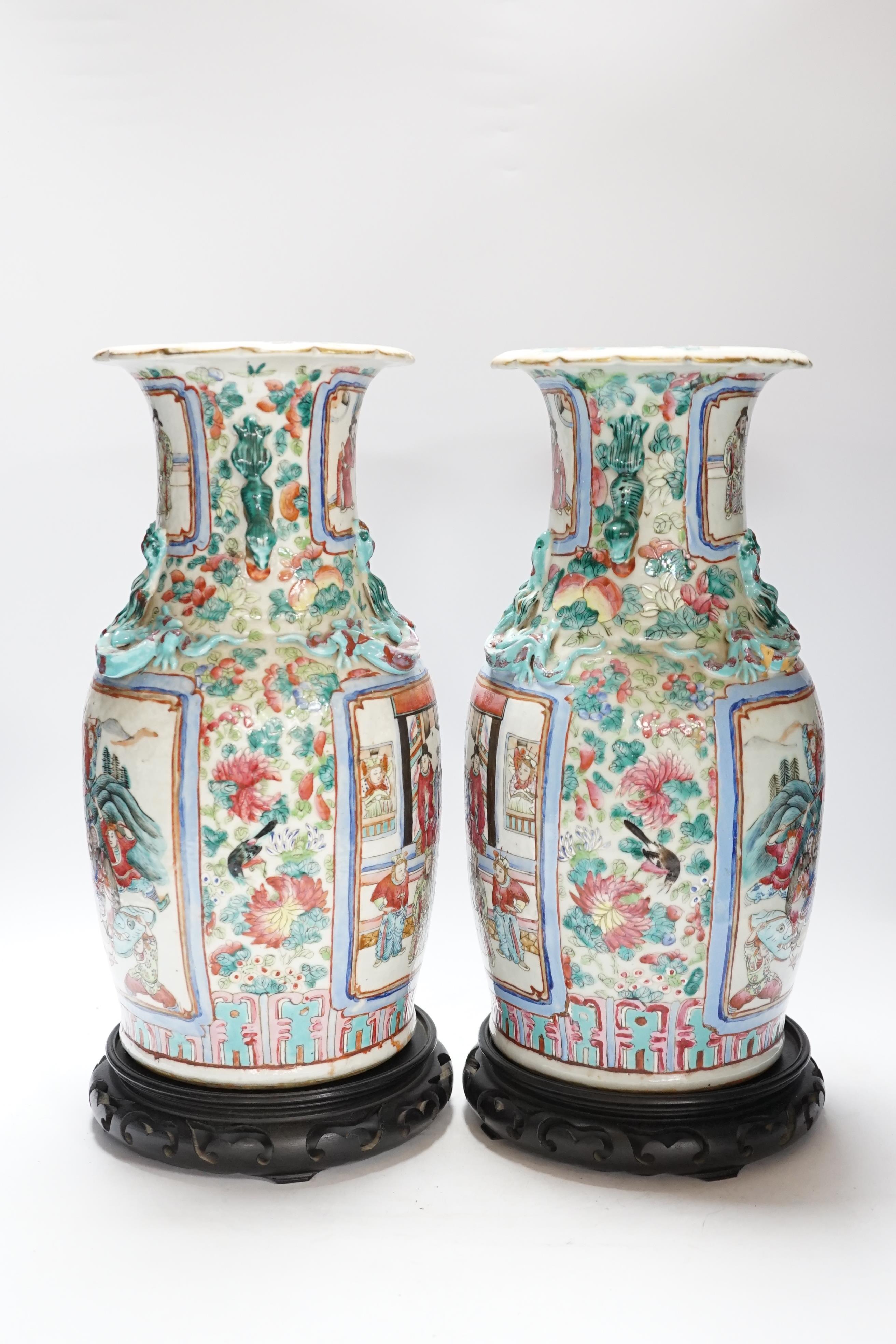 A pair 19th century Chinese famille rose ‘warriors’ baluster vases and stands, 39cm high including stands